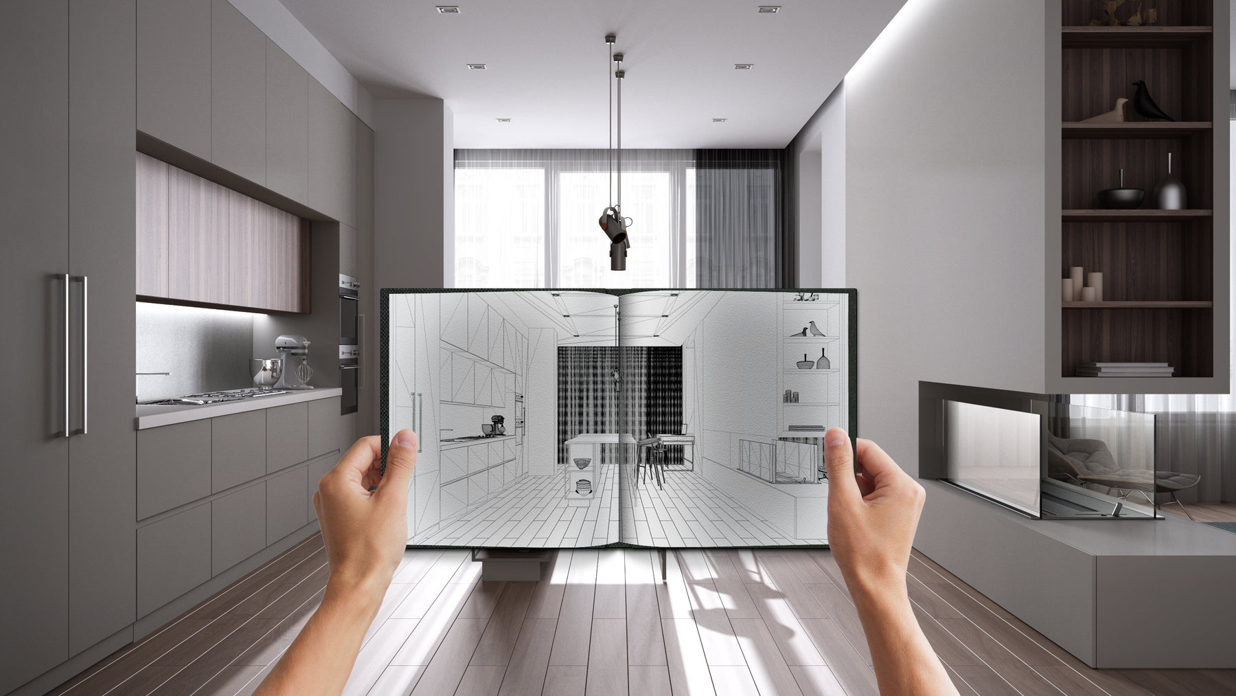 Open book displaying a kitchen design, placed in front of a modern kitchen.