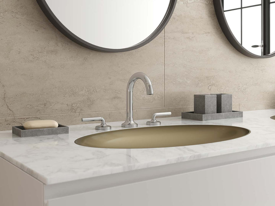 Pfister Tenet 2-handle 8-inch widespread bathroom faucet in polished chrome, installed on a white marble countertop in a contemporary bathroom.
