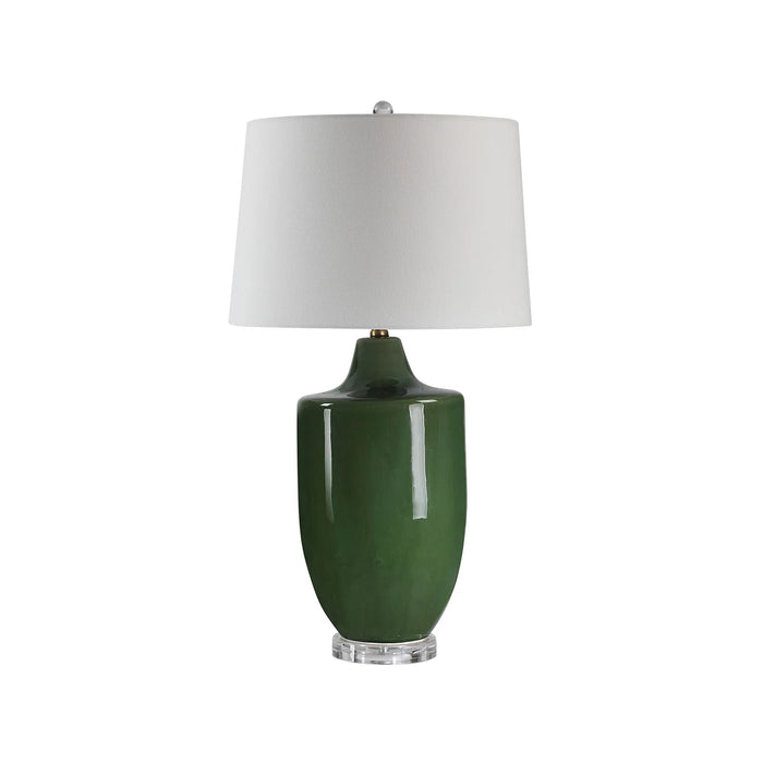 Green table lamp with a white shade on a white background