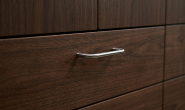CBH 220 bar pull in bright chrome finish installed on dark wood drawer front