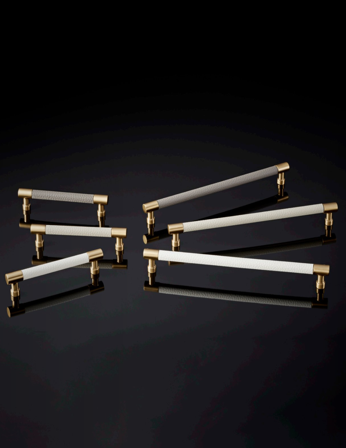 Comparison chart of Häfele Elite Leather cabinet handles in matte gold with Winter, Oyster, and Pewter faux leather finishes in 128 mm and 256 mm centre-to-centre sizes.