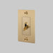 Gold light switch on a gray background