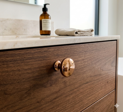 CBH 502 Classic Dome Cabinet Knob in bright bronze finish installed on a wood drawer