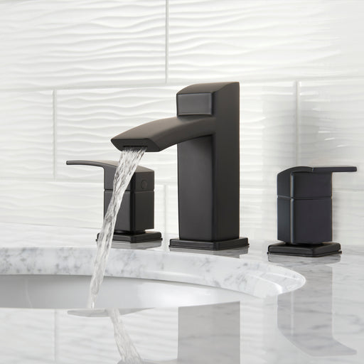 Pfister Kenzo 2-handle 8-inch widespread bathroom faucet in matte black, installed on a white countertop in a contemporary bathroom, with water gently flowing from the spout.