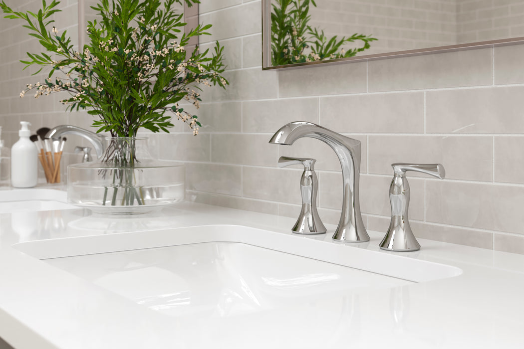 Pfister Rhen 2-handle 8-inch widespread bathroom faucet in polished chrome, installed on a white countertop in a contemporary bathroom.