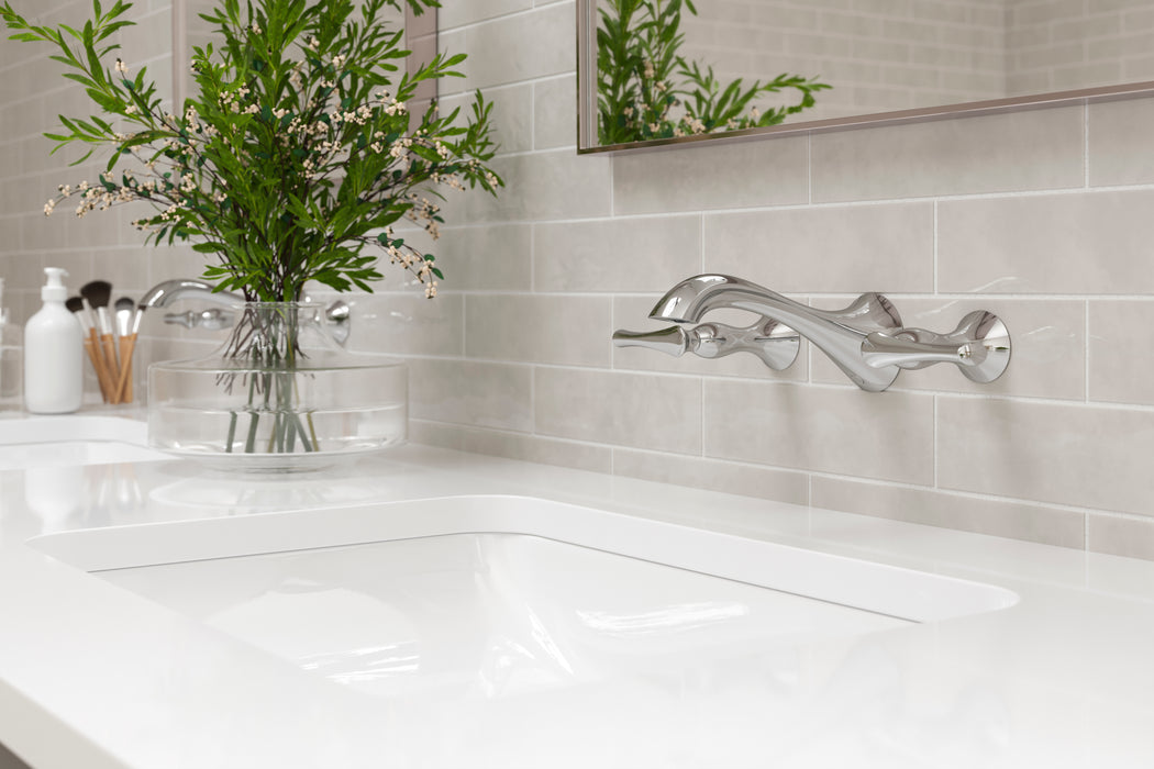 Pfister Rhen 2-handle wall-mount bathroom faucet in polished chrome, installed above a white undermounted sink on a clean, modern countertop in a contemporary bathroom.