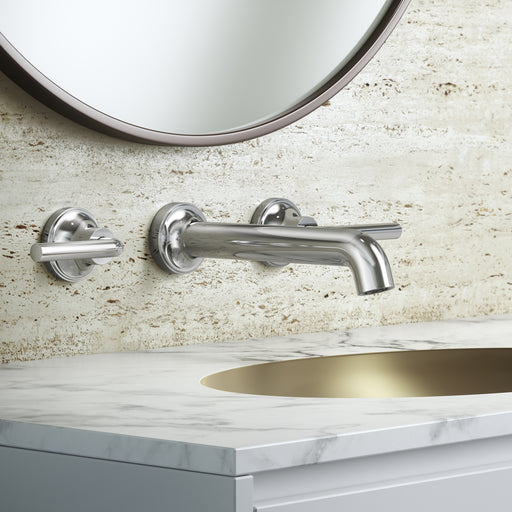 Pfister Tenet 2-handle wall-mount bathroom faucet in polished chrome, installed above a white undermounted sink on a clean, modern countertop in a minimalist bathroom.
