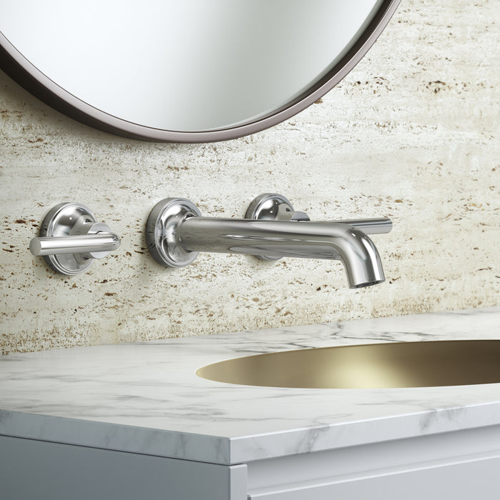Pfister Tenet 2-handle wall-mount bathroom faucet in polished chrome, installed above a white undermounted sink on a clean, modern countertop in a minimalist bathroom.