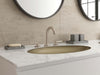 Pfister Tenet 2-handle 8-inch widespread bathroom faucet in brushed nickel, installed on a white marble countertop in a modern bathroom.