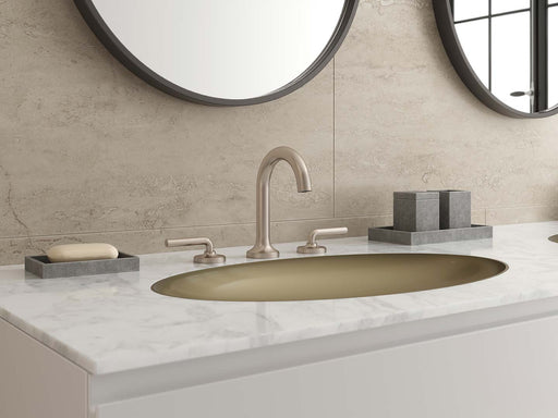 Pfister Tenet 2-handle 8-inch widespread bathroom faucet in brushed nickel, installed on a white marble countertop in a modern bathroom.