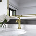 Pfister Tisbury faucet in brushed gold installed on a white marble countertop, highlighting its elegant traditional design in a luxurious bathroom setting.
