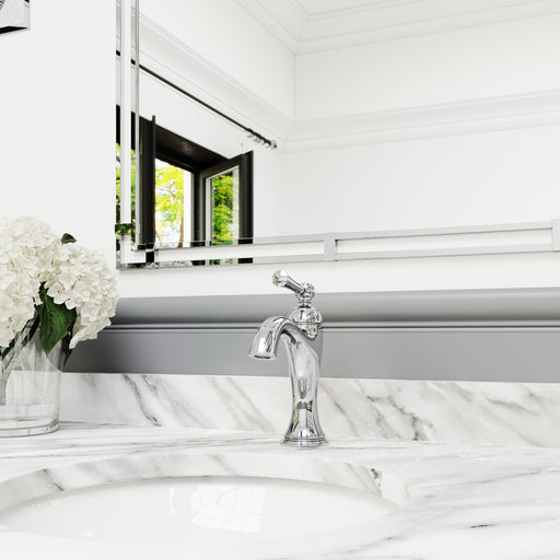 Pfister Tisbury faucet in polished chrome installed on a white marble countertop, showcasing its elegant design in a traditional bathroom setting.