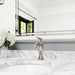 Pfister Tisbury faucet in polished nickel installed on a white countertop, emphasizing its sophisticated design in a traditional bathroom setting.
