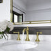 Pfister Tisbury 2-handle 8-inch widespread bathroom faucet in brushed gold, installed on a white marble countertop in a modern bathroom, with water flowing gracefully from the spout.