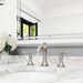 Pfister Tisbury 2-handle 8-inch widespread bathroom faucet in brushed nickel, installed on a white marble countertop in a transitional bathroom, with water gently flowing from the spout.