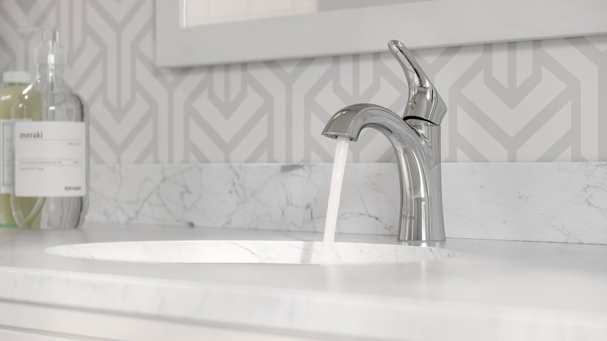 Pfister Weller single-control bathroom faucet in polished chrome, installed on a marble countertop in a contemporary bathroom with neutral-toned decor.