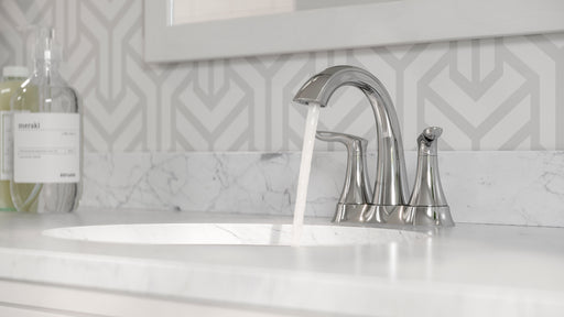 Pfister Weller 2-handle 4-inch centerset bathroom faucet in polished chrome, installed on a white countertop in a modern bathroom, with water flowing gently from the spout.