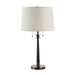 Table lamp with a white shade and black and bronze base on a white background