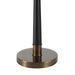 Black and brass lamp base on a white background