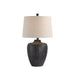 Table lamp with textured black base and beige lampshade on a white background