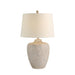 Table lamp with textured base and beige lampshade on a white background