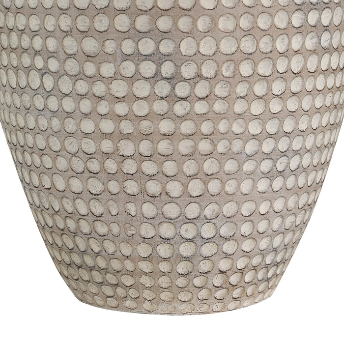Textured table lamp with circular pattern on a white background