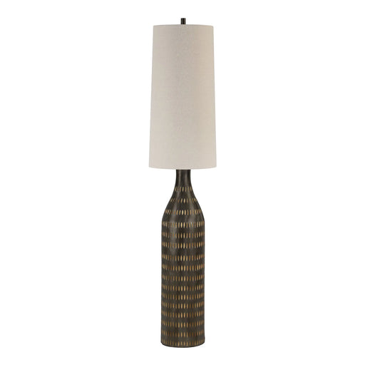 Decorative floor lamp with a textured base and oatmeal shade on a white background