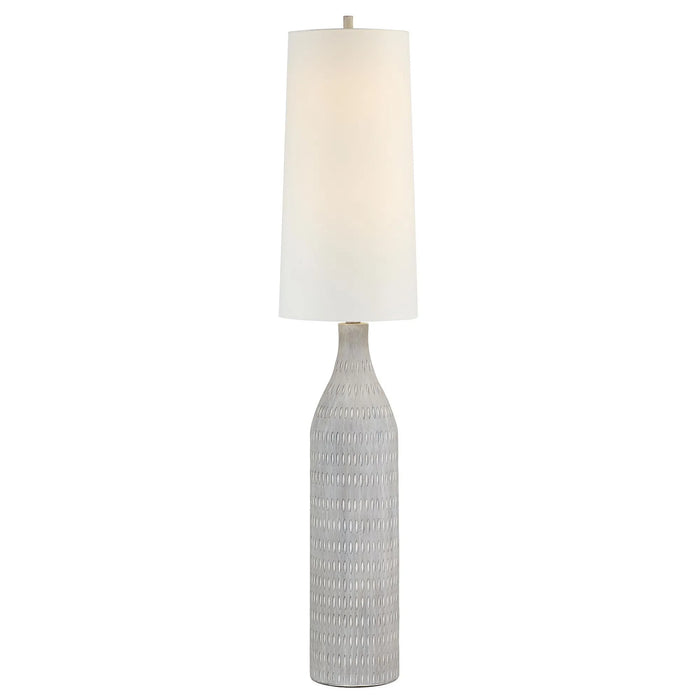 Floor lamp with textured cream base and oatmeal shade on a white background