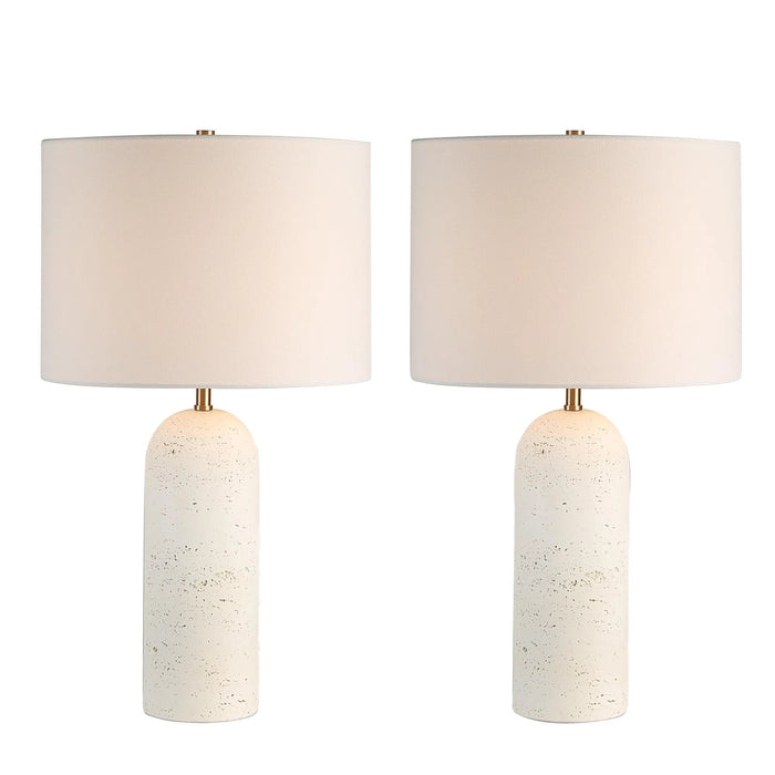 Two table lamps with white ceramic bases and white lampshades on a white background