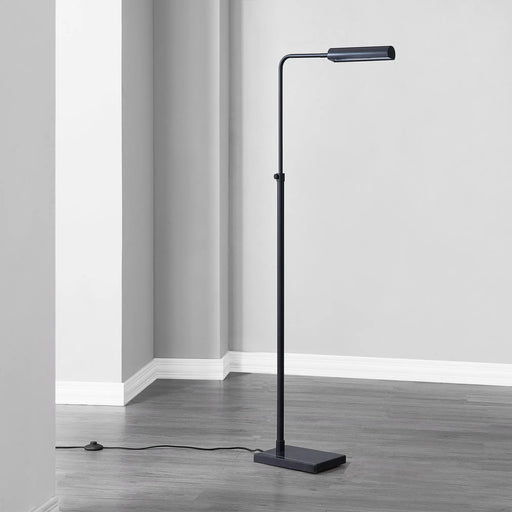 Black floor lamp in a room with gray walls and flooring