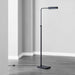 Black floor lamp in a room with gray walls and flooring