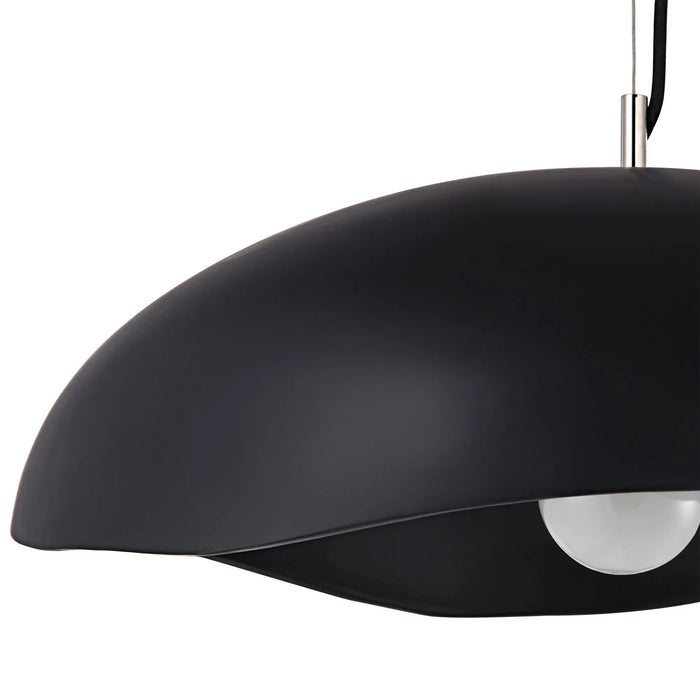 Black pendant dome light with a white bulb on a white background