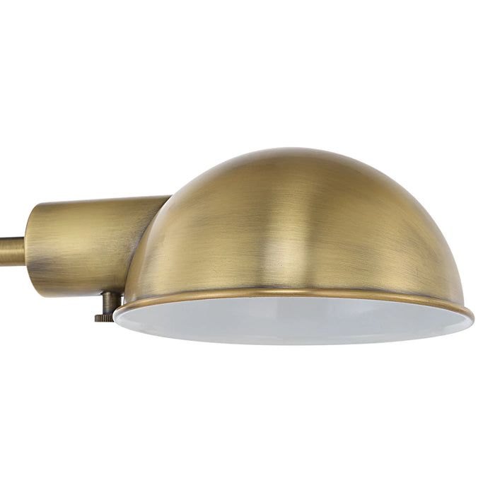 Brass-colored dome task light on a white background