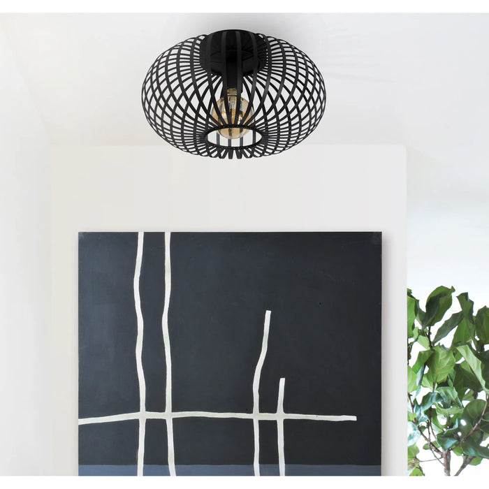 Black ceiling light fixture above a black abstract painting with white lines on a white wall.