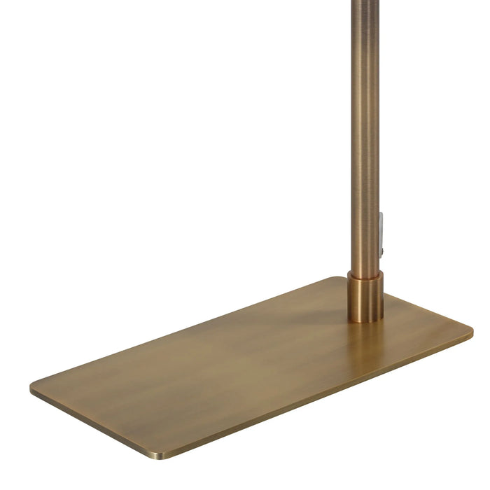 Brass floor lamp with a rectangular base on a white background