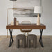 Modern home office with wooden desk, reading floor lamp, books, and stools.