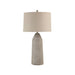 Table lamp with textured base and beige shade on a white background