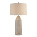 Table lamp with textured base and beige lampshade on a white background