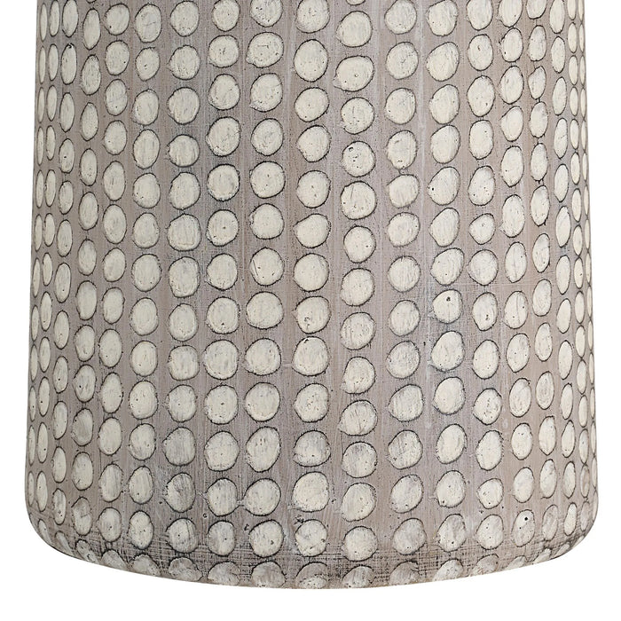Textured lamp with a pattern of raised dots on a neutral background
