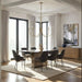 Modern dining room with a wooden table and chairs, chandelier, and large windows.