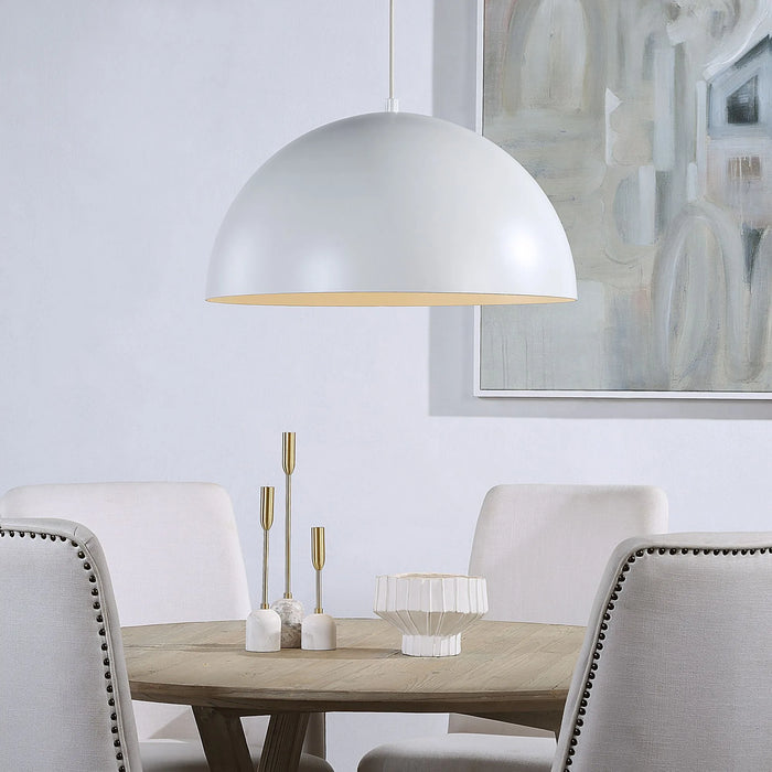 Dining room with a white pendant light, wooden table, and abstract art on the wall.