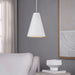 White textured pendant light hanging in a room with a gray wall, white sofa, and framed artwork.