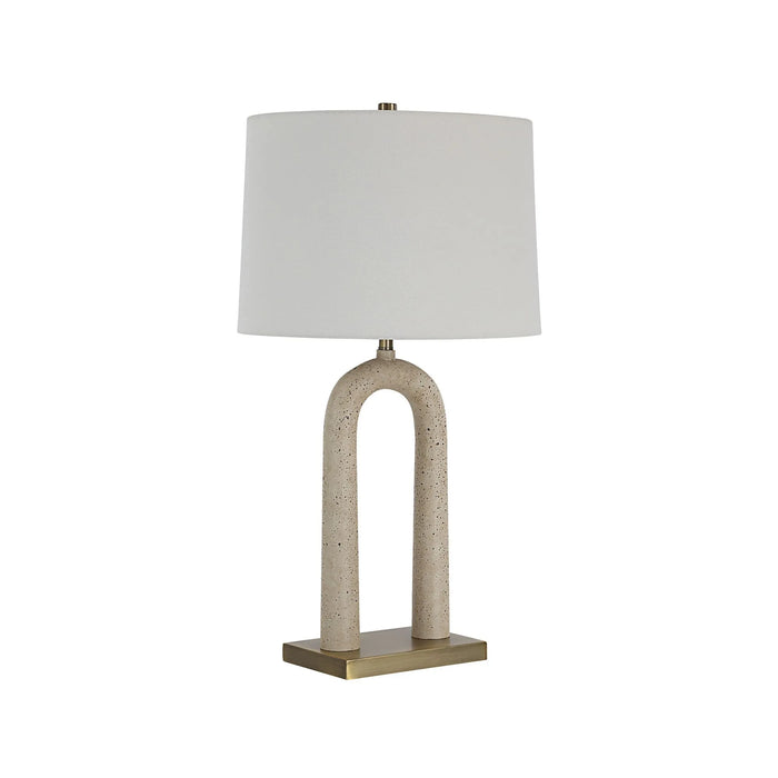 Table lamp with a white shade and beige arch-shaped base on a white background