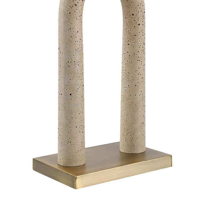 Beige travertine lamp base columns with a brass base on a white background