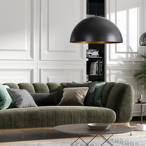 Modern living room with a green sofa, black pendant lamp, and decorative pillows.