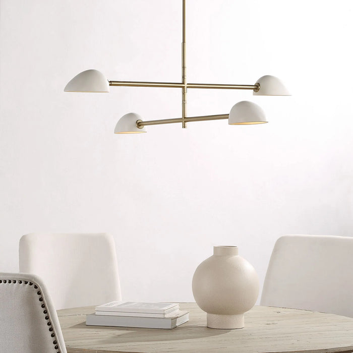 Modern chandelier with white shades and gold accents in a minimalistic room.