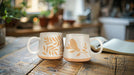 Oversized ivory and tan bird mug displayed with autumn table décor