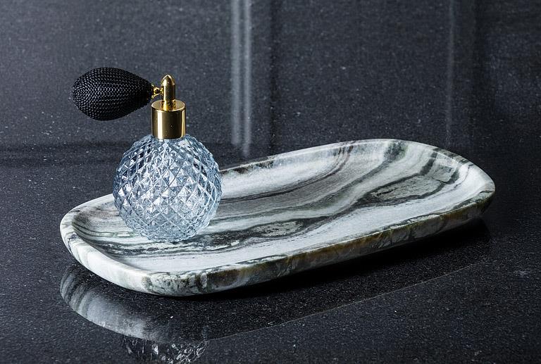 Small black marble tray styled with a decorative soap dispenser