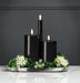 Black marble tray styled with pillar candles and greenery