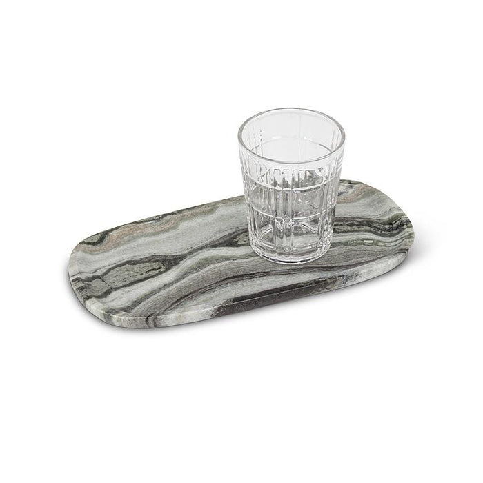 Oblong black marble serving tray styled with a drinking glass